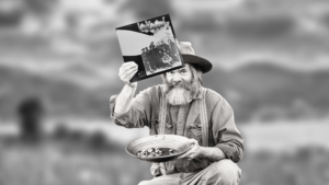 gold miner holding a sealed vinyl record